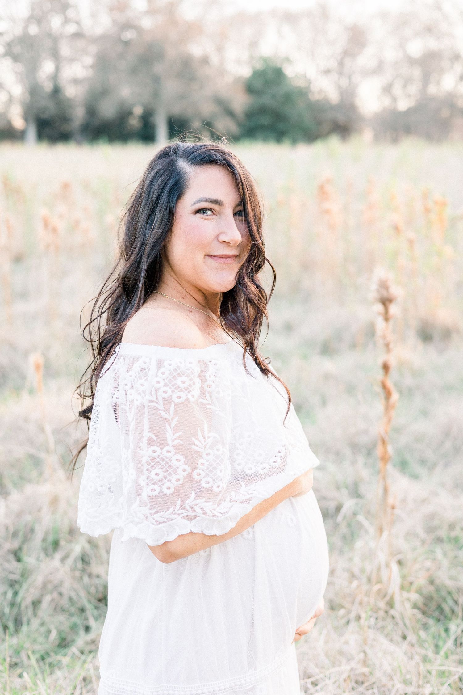 Augusta GA maternity photographer captures glowing mother in natural light with flowing gown