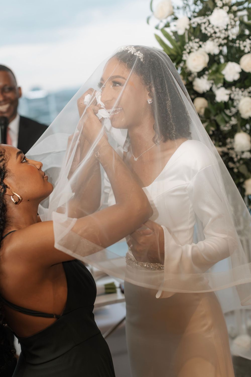 Joyful celebration moment at wedding with bride in white dress and veil.