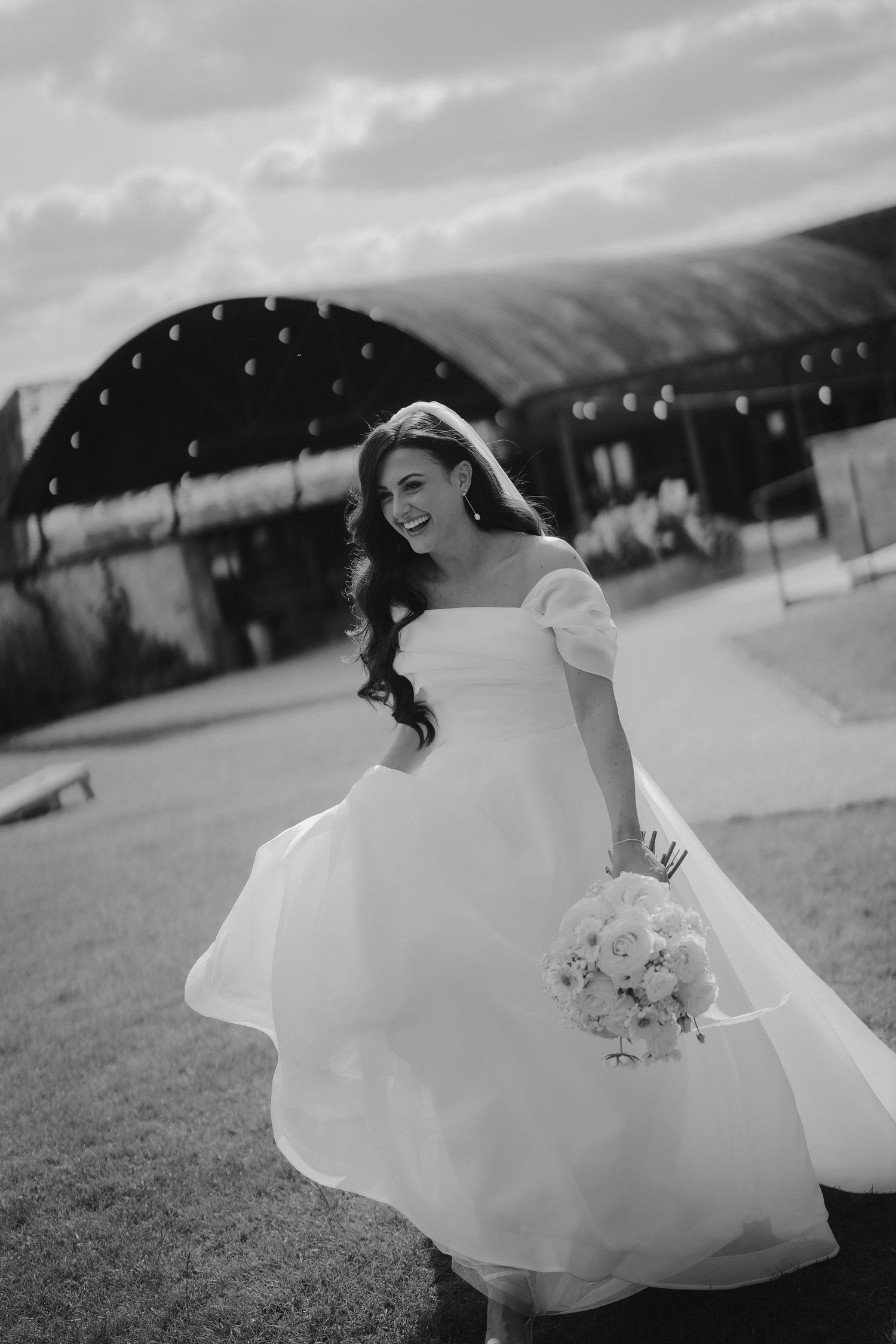 bride walking and laughing at yardspace old gore in cirencester