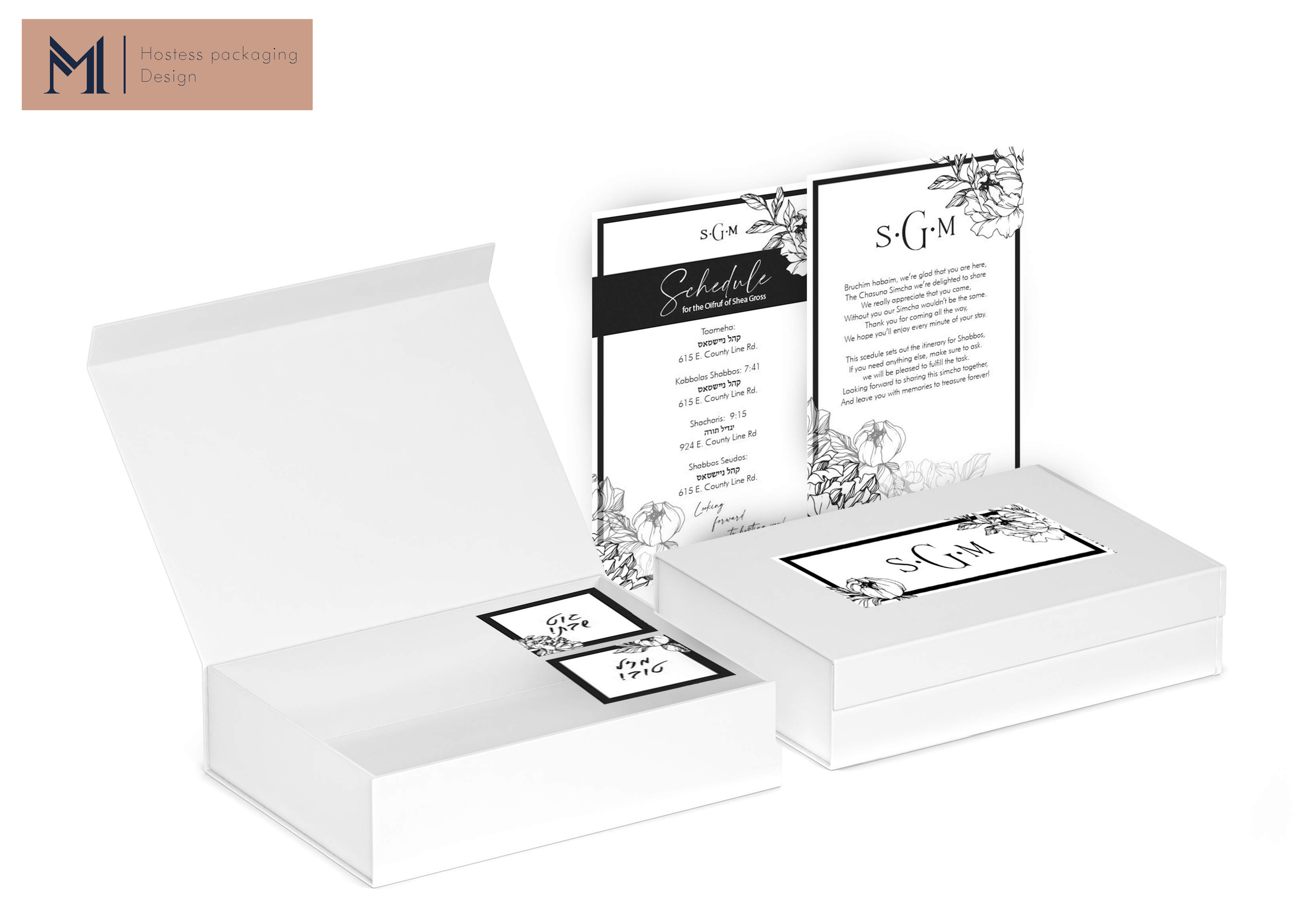 White luxury product packaging boxes with decorative black floral menu cards displayed on a light background.