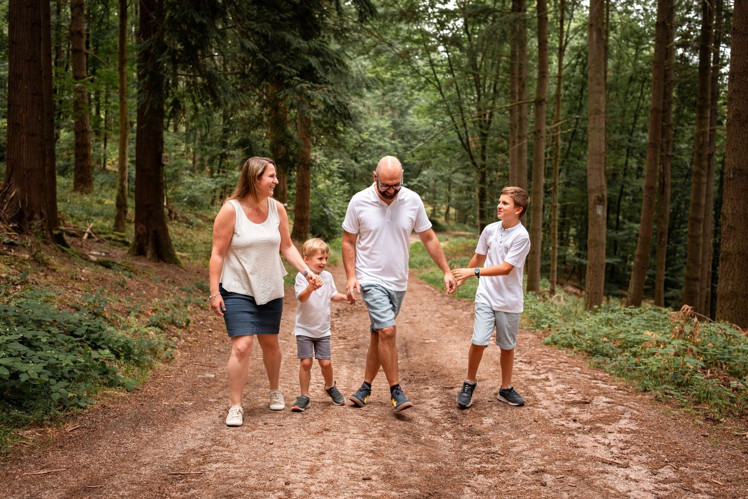 Enfants courant dans les feuilles pendant une séance photo famille