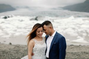 Bride and groom sharing a tender moment with a glacier backdrop at Vatnajokull in Iceland.