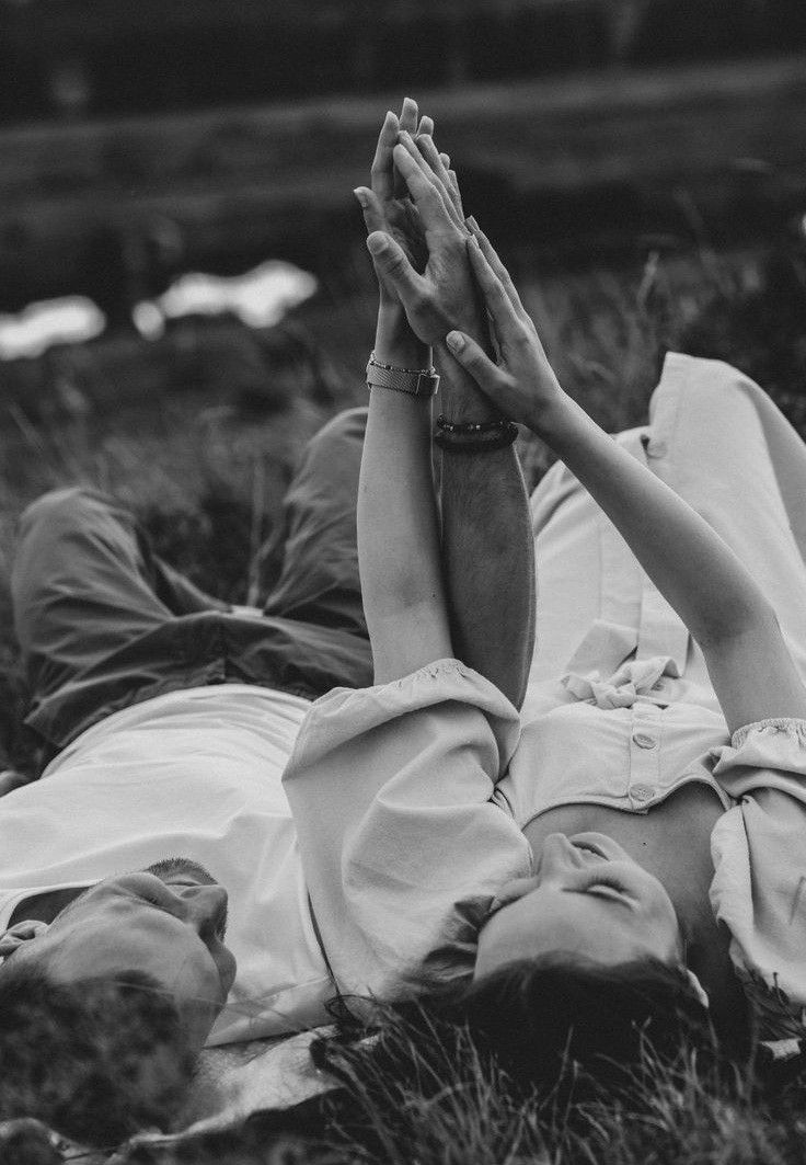 A joyful romantic moment between a couple in western attire as they embrace in a mountain meadow.