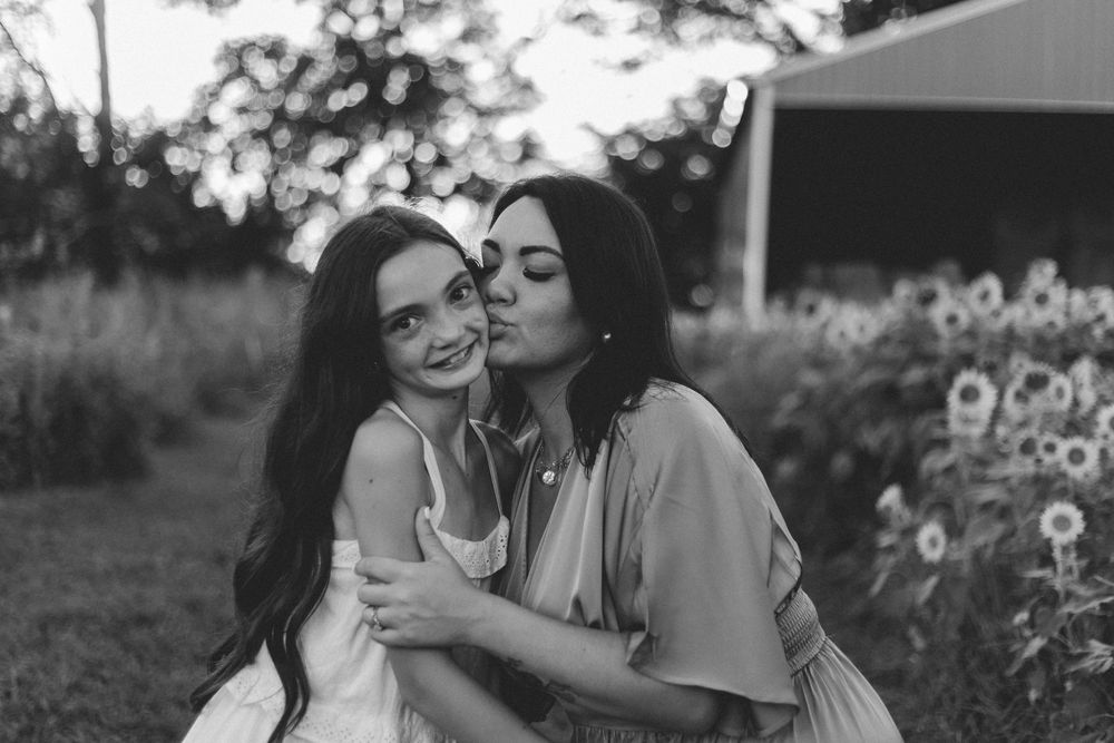 Black and white intimate photo collage showing loving moments between two people in various outdoor settings.