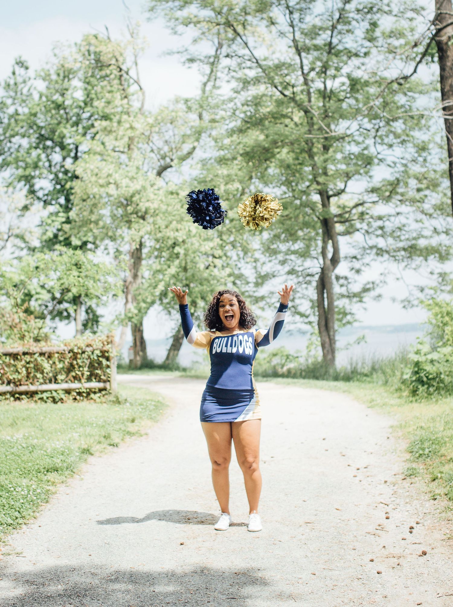 A series of lively candid shots shows a curvy woman in jean shorts and a navy top joyfully posing in a park setting.