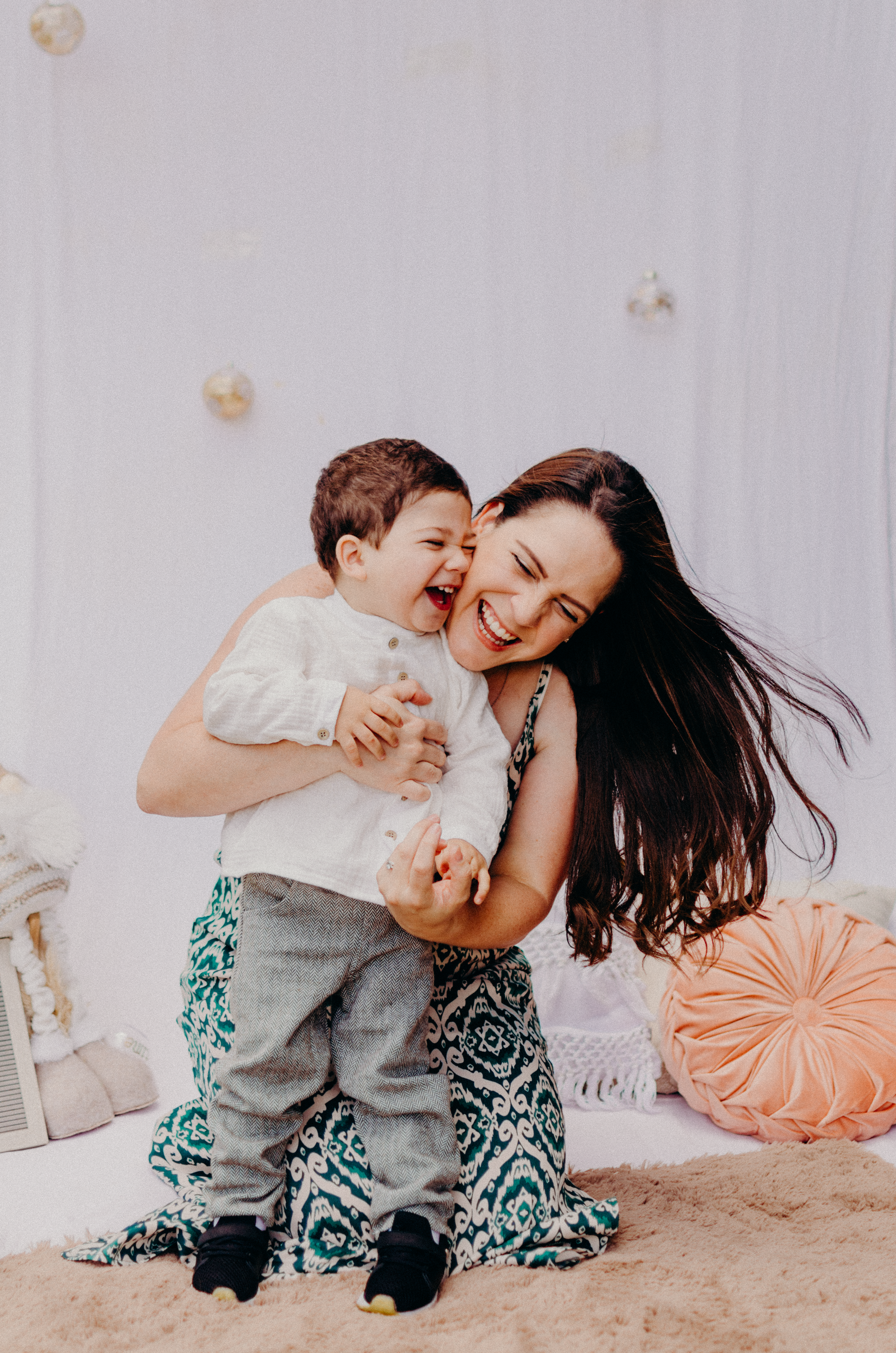 Joyful indoor portrait showing natural candid laughter and embraces.