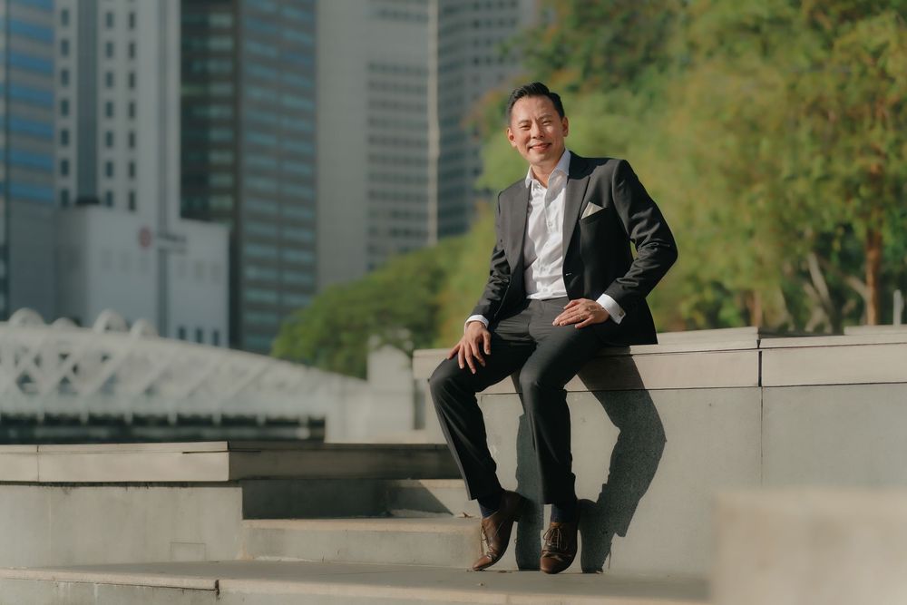 Professional headshots taken on outdoor urban steps showing figure in business attire posing from different angles.