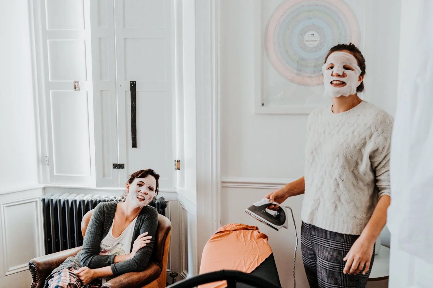 Playful getting ready moments as wedding party members put on protective face masks.