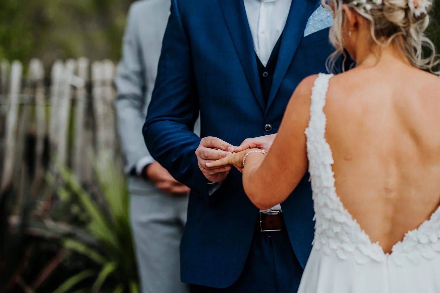 Intimate wedding ceremony moment between couple on a cliffside location.