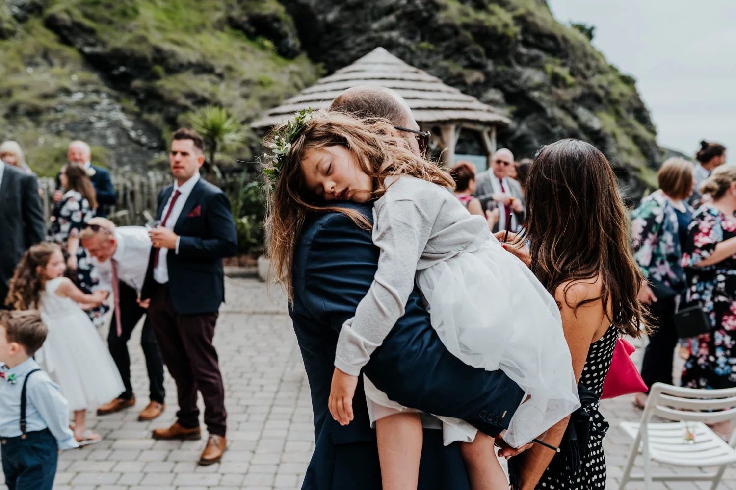Candid moments of wedding guests celebrating and dancing at outdoor mountain venue.