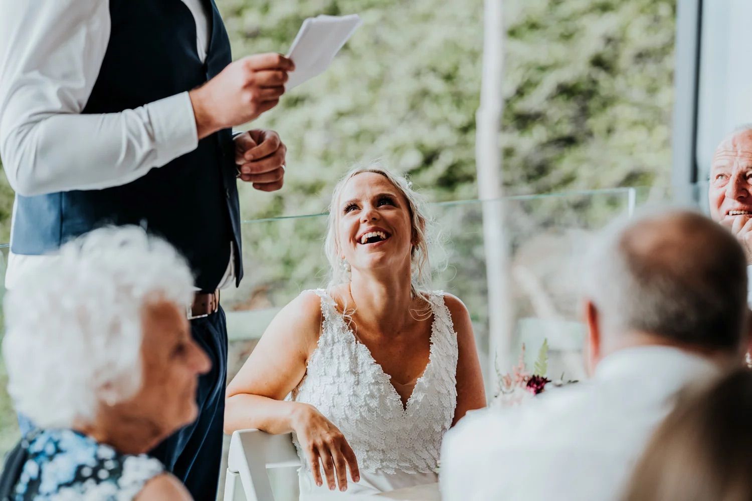 Reception celebration with guests gathered around tables outdoors.