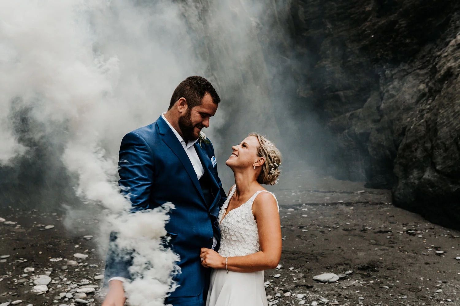Dramatic smoke effect photography at rocky beach location.
