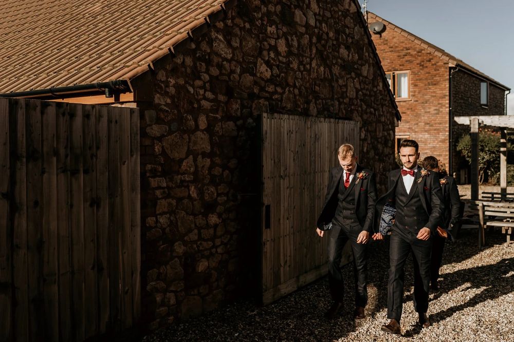 A collection of candid shots showing wedding party members walking outside a rustic brick venue.