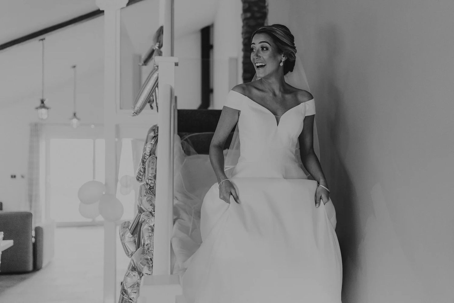 Black and white photos of a bride looking elegant in her gown during wedding preparations.