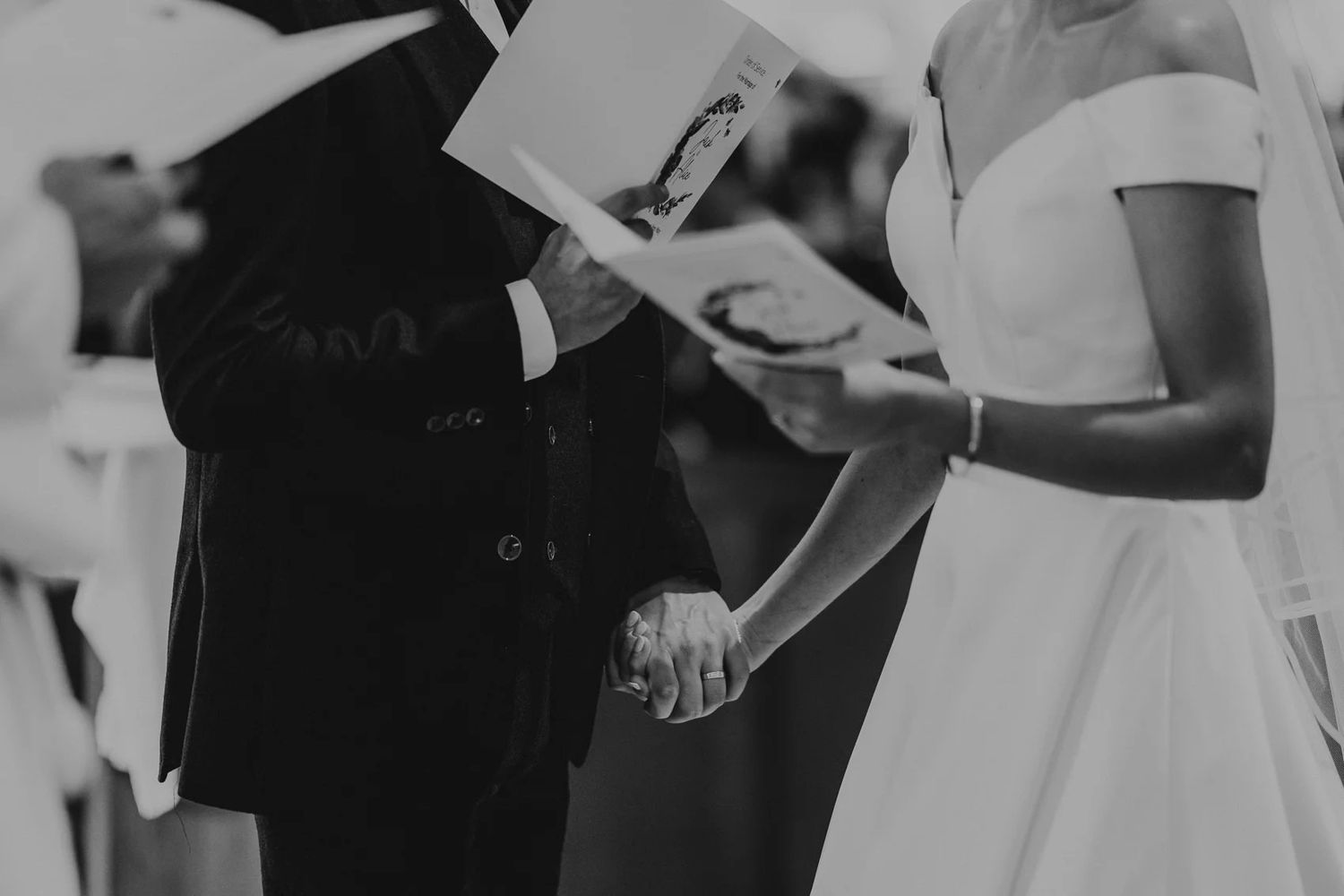 Bride and groom share letters during intimate first look moment at their wedding.