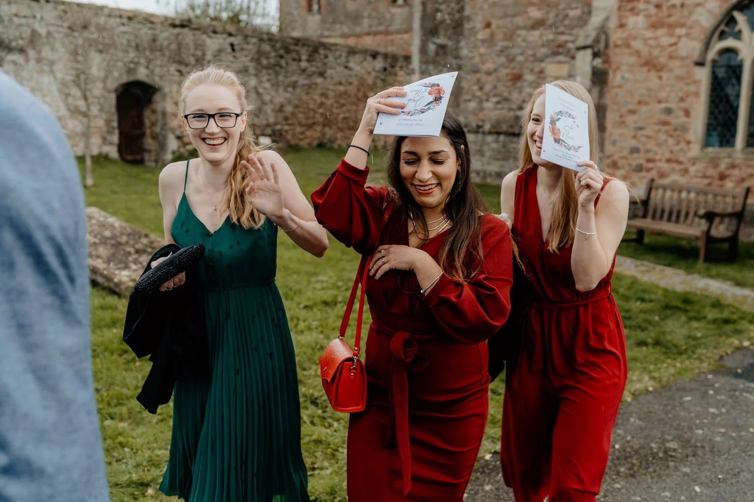 Wedding guests reacting with excitement and surprise during a special moment outdoors.