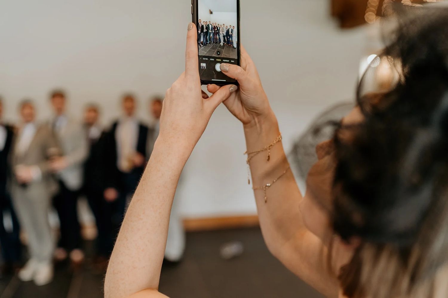 Wedding guests capture special moments on their phones during a ceremony.