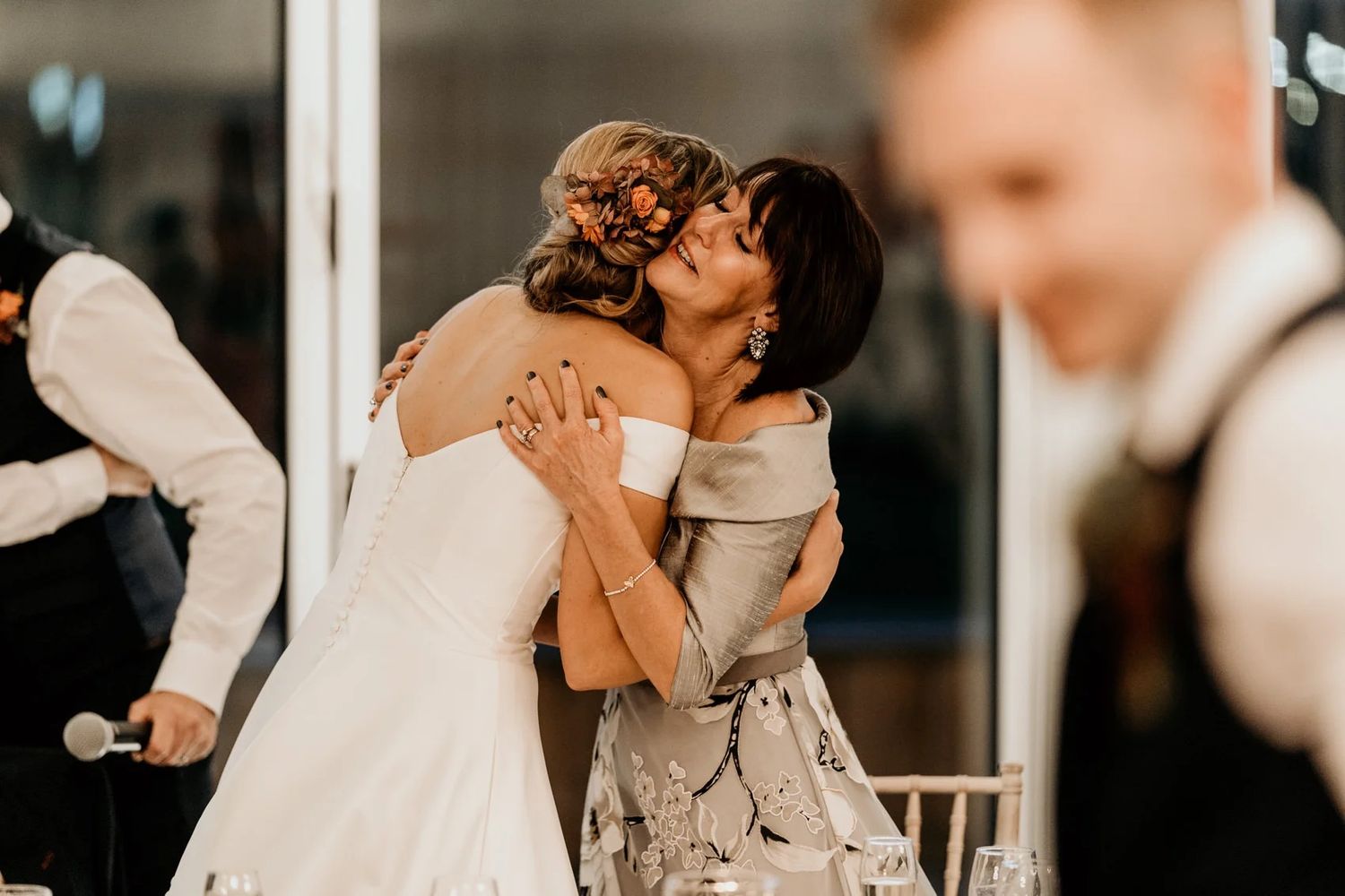 Wedding couple share intimate moments during their first dance celebration at an indoor reception venue.
