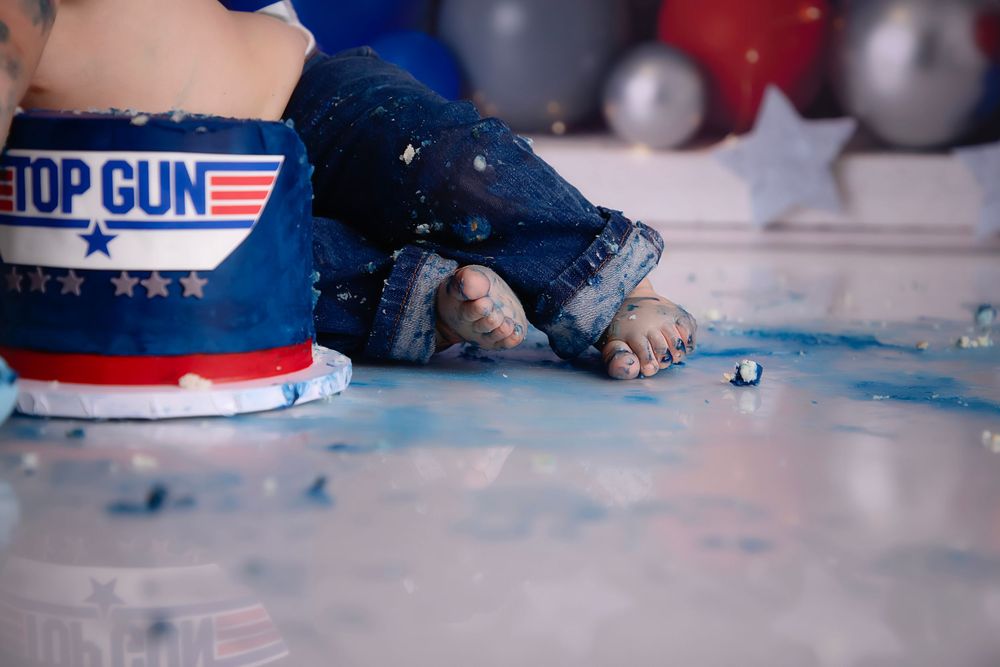 Red white and blue decorative patriotic desserts displayed on tabletop with Top Gun theme party elements.