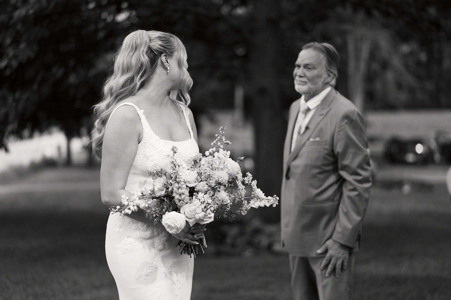 Black and white candid moments captured between a couple during their outdoor wedding ceremony.