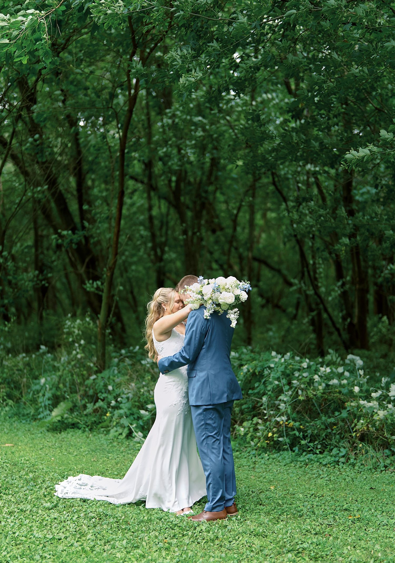 A romantic outdoor wedding sequence shows a couple embracing on green grass surrounded by lush forest scenery.