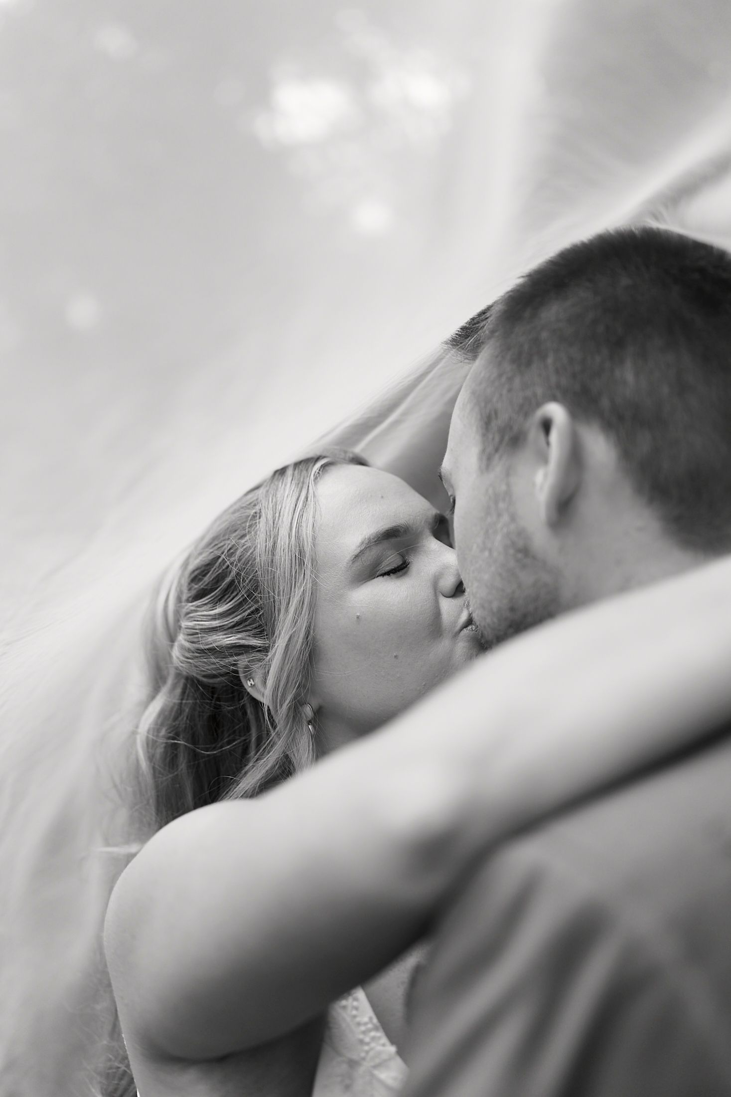 An intimate black and white close-up of a tender romantic moment between a couple.