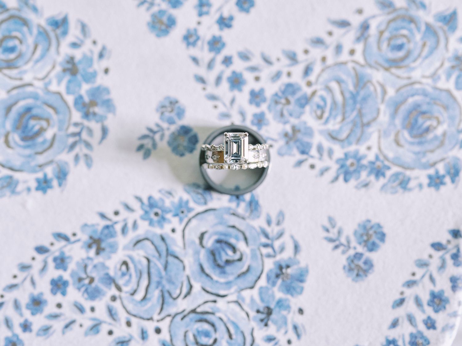 Light blue and white floral pattern with delicate watercolor flowers and swirling vines on a white background.