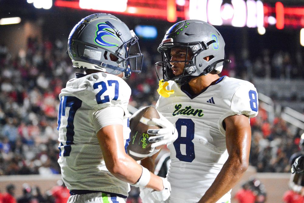 Football players celebrate after scoring a touchdown during an exciting game.