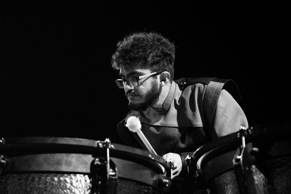 Dynamic black and white photo montage shows energetic drummer performing with intensity during a live music performance.