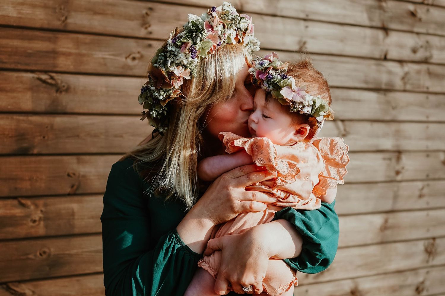 Romantic photography session with floral crowns and wooden backdrop capturing intimate moments.