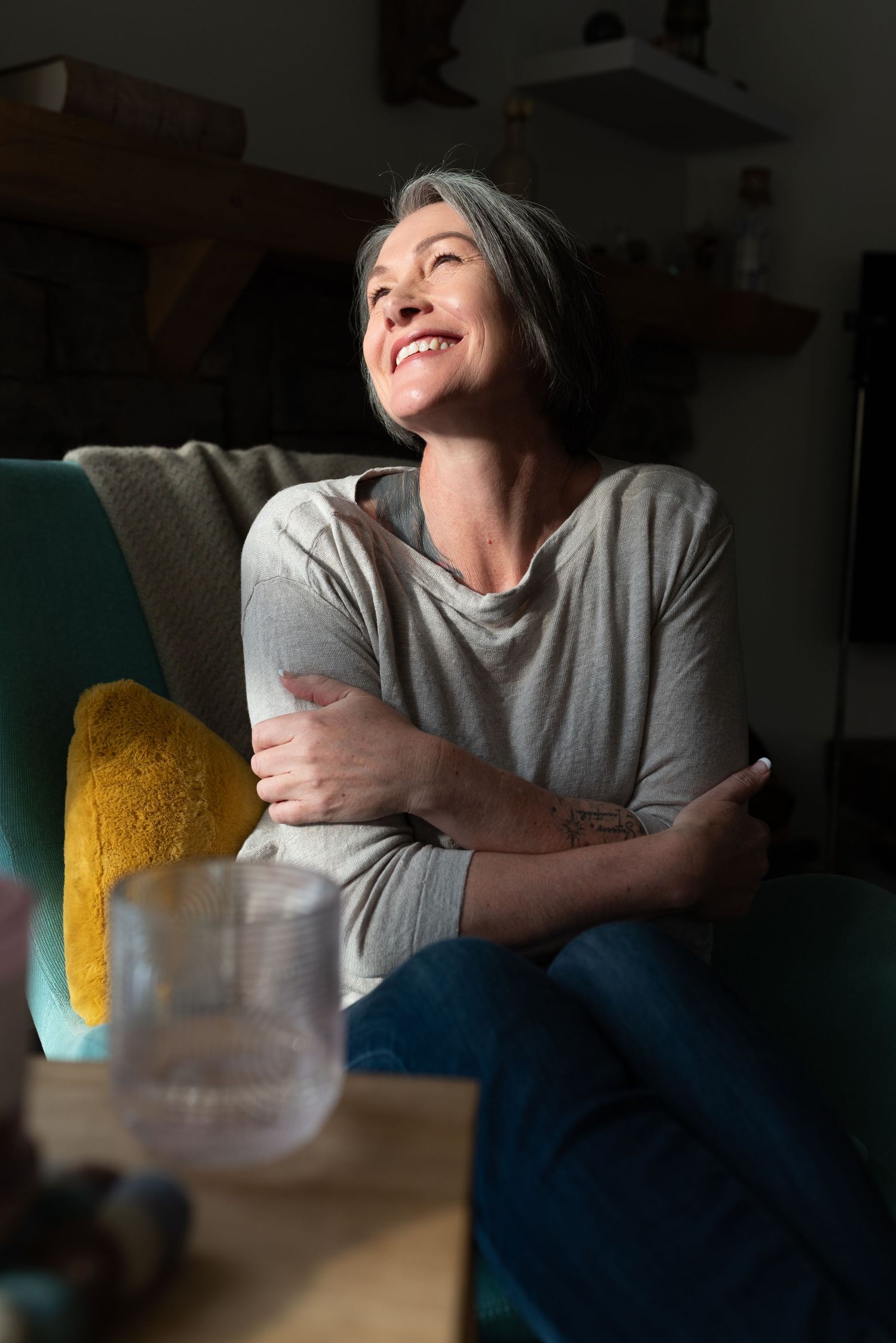 Joyful lifestyle photos showing laughter and tea time in a pink dress with fuzzy shawl.