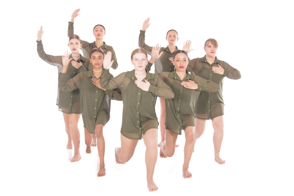 Modern dancers in olive green outfits strike dynamic poses in sequential motion.