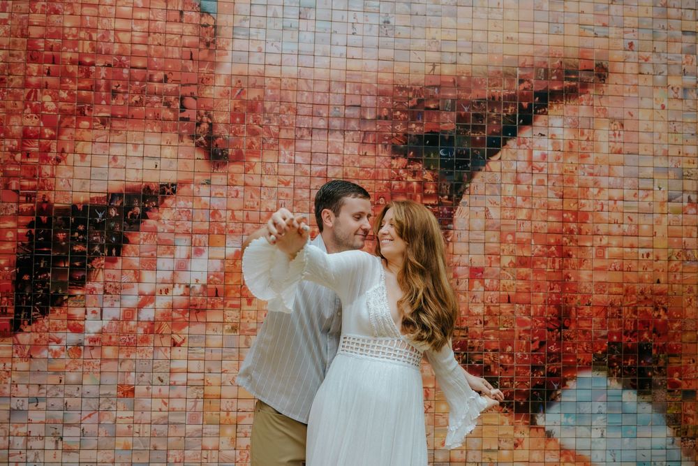 Expecting parents smiling at each other after announcing the baby’s gender during the shoot.