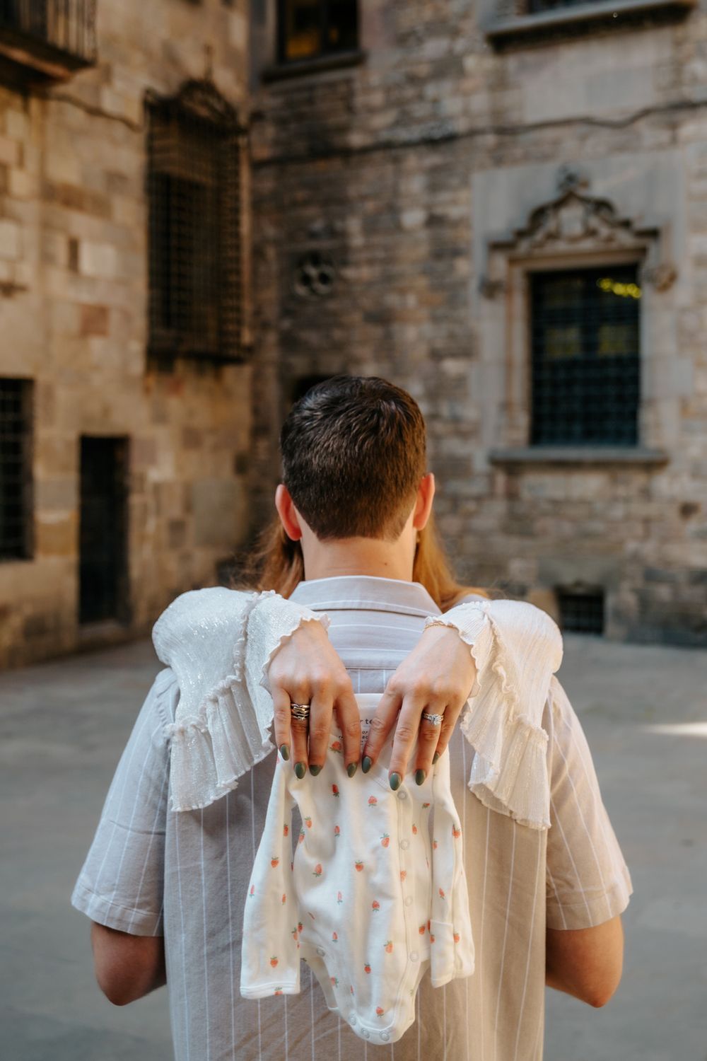 Couple holding hands tightly with love and anticipation in Old City.