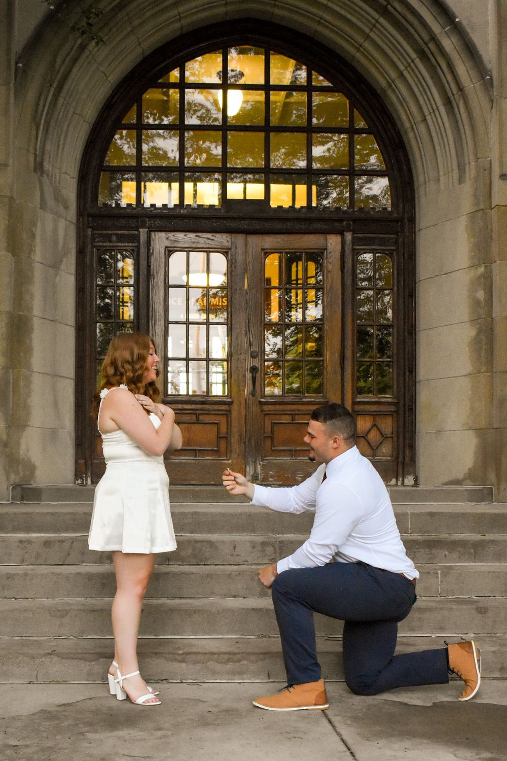 A romantic sequence of marriage proposal photos taken in stone archways with warm lighting at sunset.