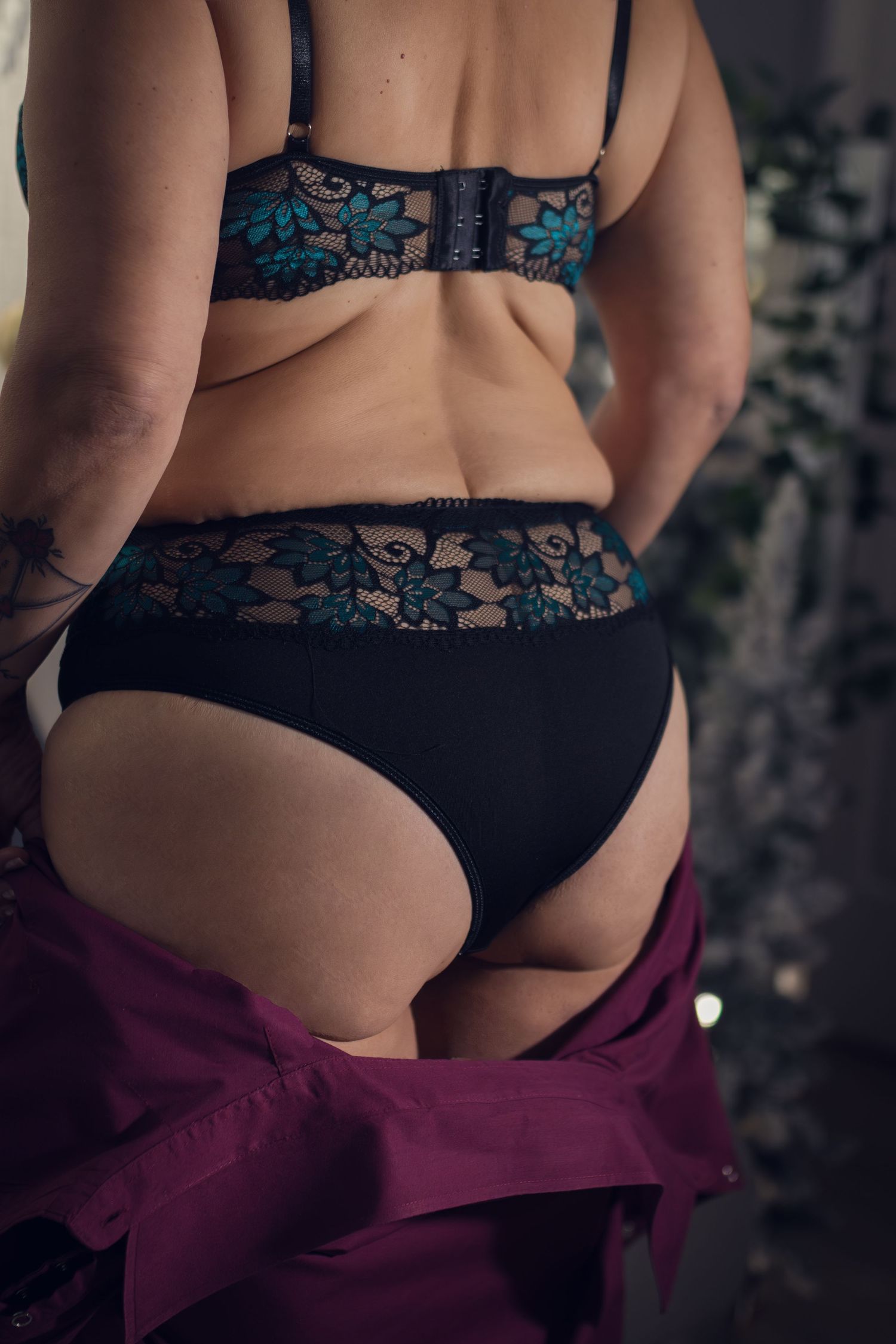 A woman in her 50s celebrates her anniversary with a special boudoir session personalized as a gift for her husband.