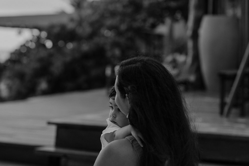 Mother holding child in black and white portrait during Tulum family photoshoot at La Zebra.