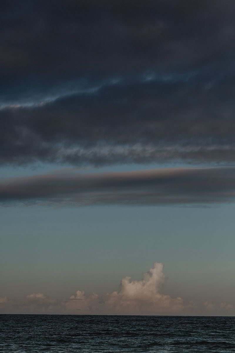 Stormy Caribbean sky over the ocean in Tulum, editorial travel photography detail.
