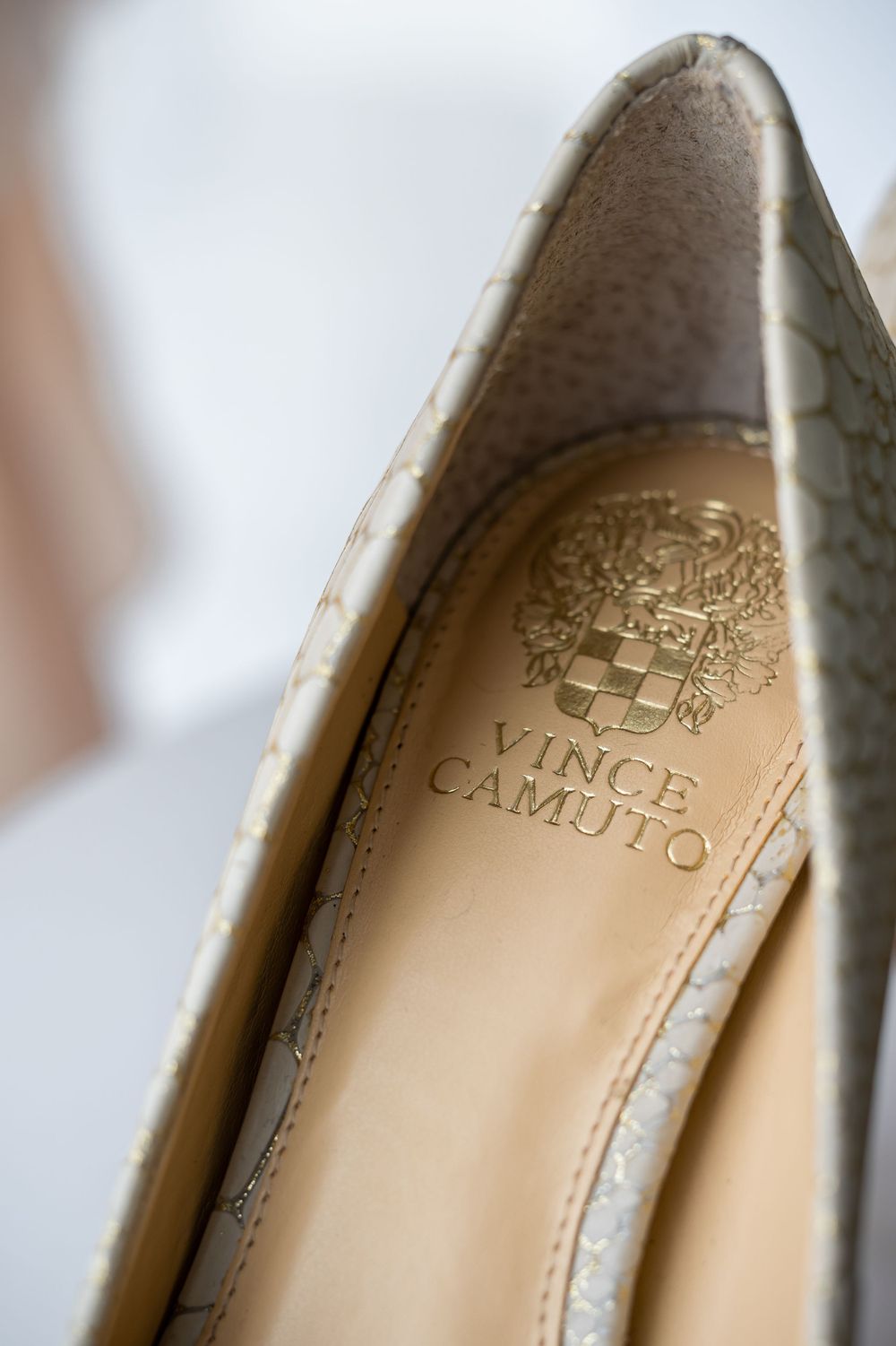 Close-up detail of a Vince Camuto designer shoe label showing elegant branding.