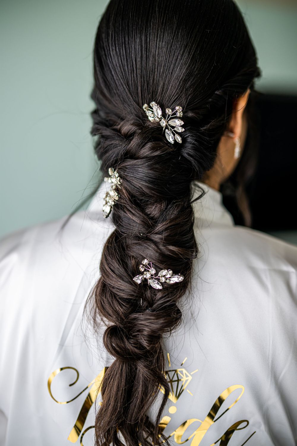Elegant braided hairstyle adorned with crystal hair accessories.