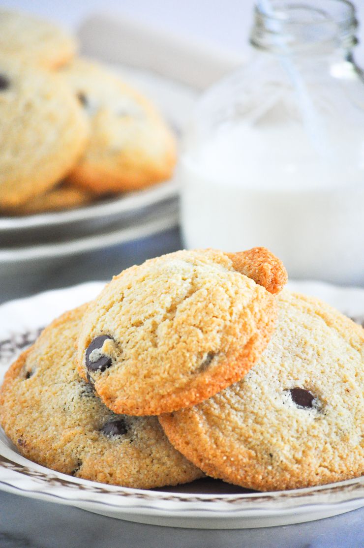 Fresh baked chocolate chip cookies served on white plates.