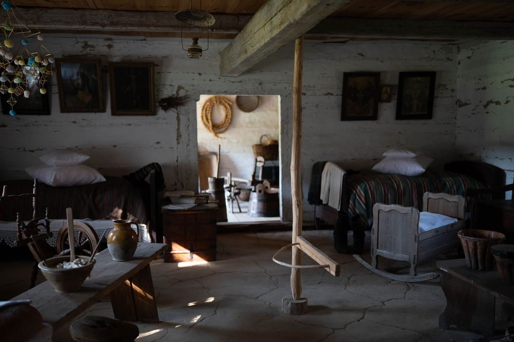 Interior of a rustic room with vintage furniture and sunlight streaming through windows.