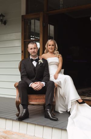 Newlyweds share intimate moments on white porch bench in sequence of casual poses.