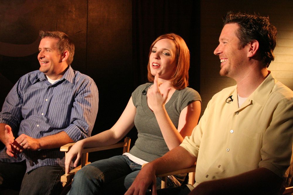Panel discussion participants sharing laughs while seated during an entertainment event.