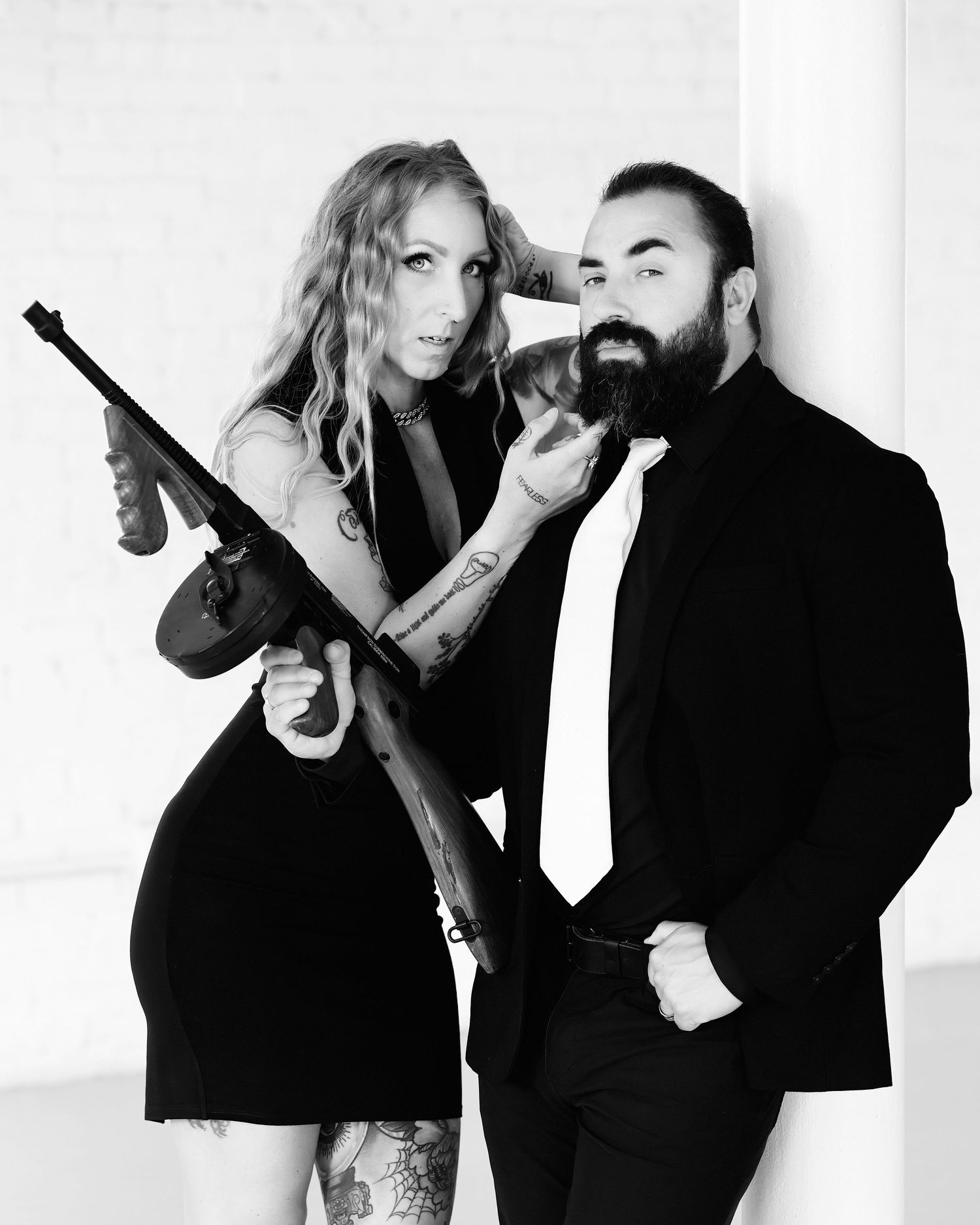 David G Holt Photography - Black and white fashion series showing playful poses with props against white background.