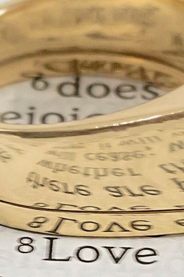 Closeup image of gold ring reflecting the word Love. Boise wedding photographer.