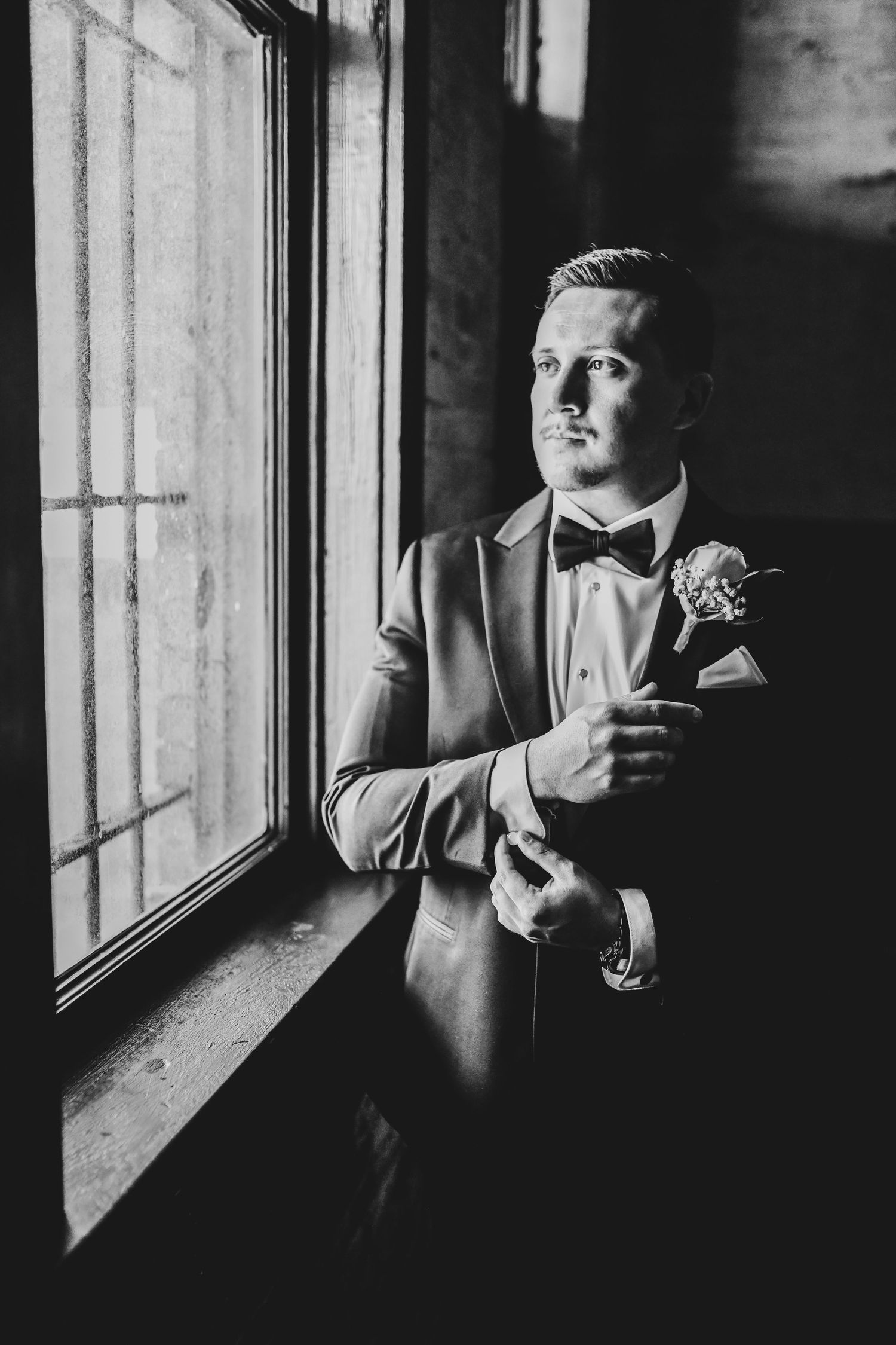 Groom getting ready in classic black-tie attire