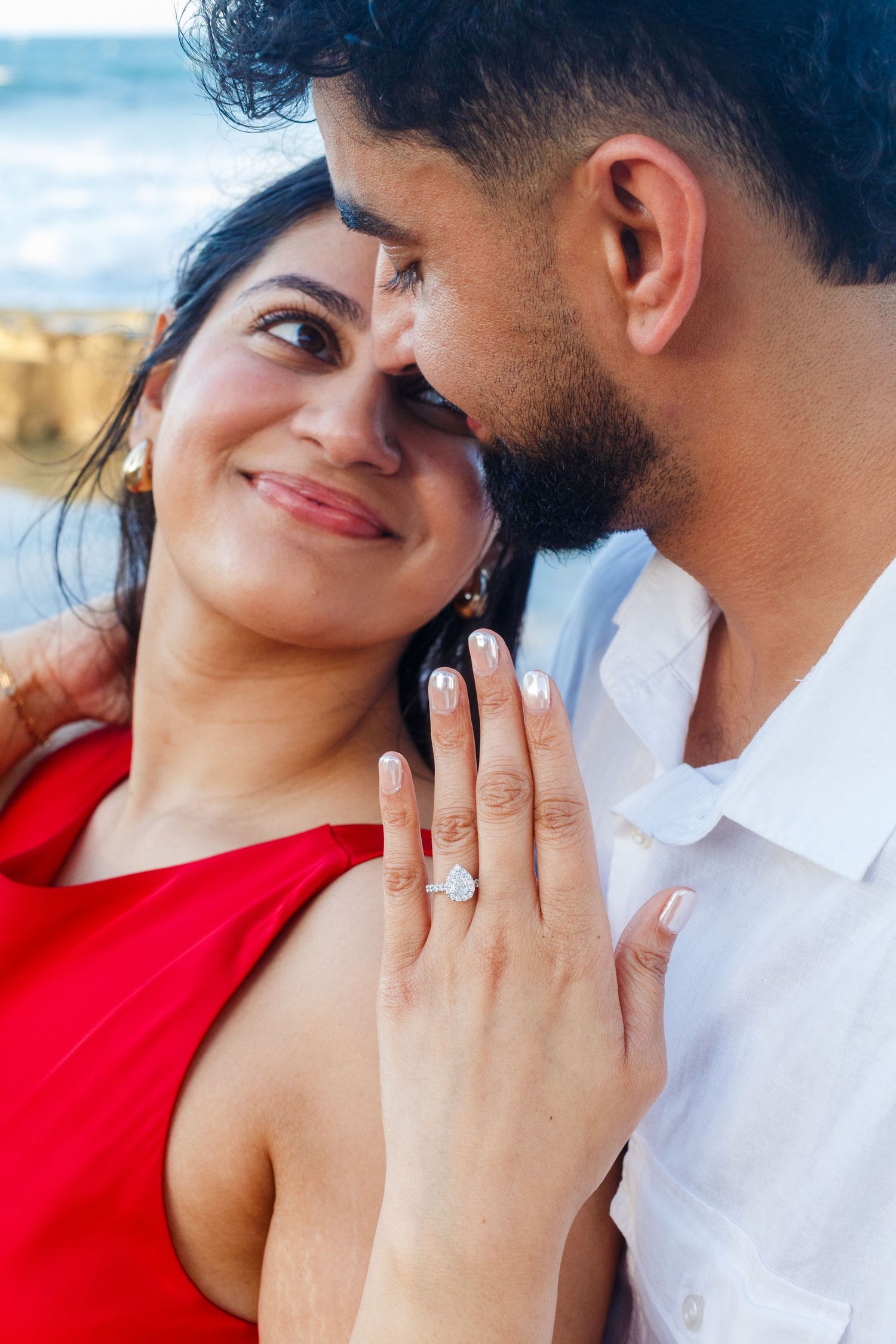 Couples portrait. Proposal and engagement session. Man and woman on the beach. Ring shot. Kikita Surf Beach, Dorado, Puerto Rico.