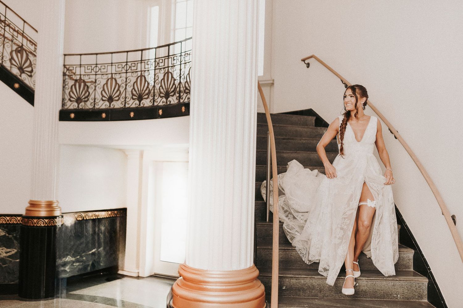 Bride walking down the stairs at Hubbard Hall, captured in a timeless and elegant wedding moment