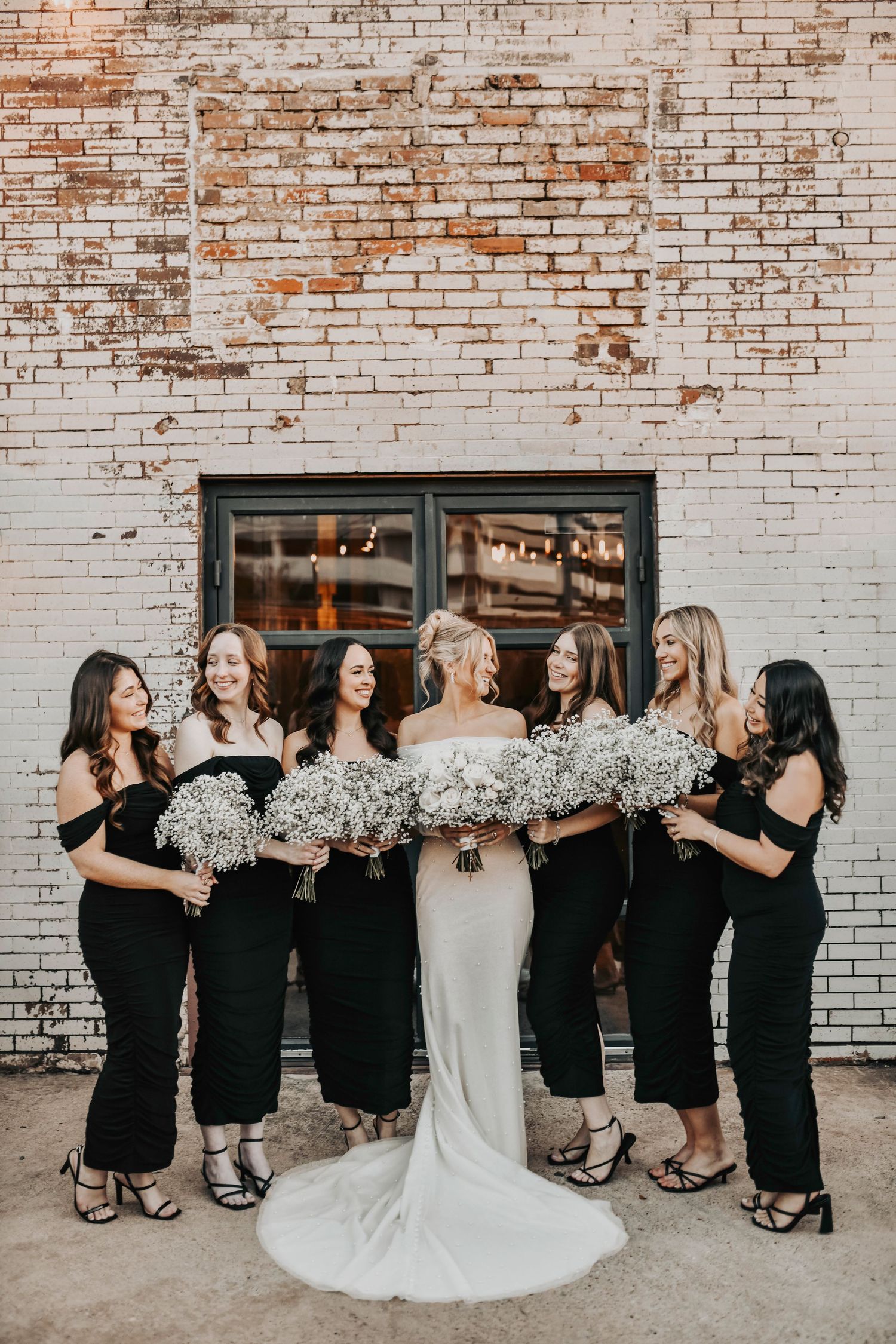 Bridal party gathered around bride before ceremony